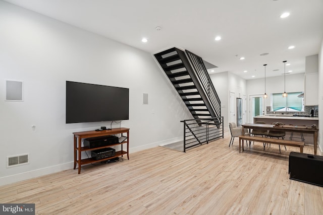 1448 N Myrtlewood St, Philadelphia, PA 19121 - living room featuring stairs, light wood-style flooring, and recessed lighting