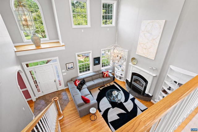 2865 Proffit Rd, Charlottesville, VA 22911 - living room with a chandelier, wood finished floors, plenty of natural light, and a towering ceiling
