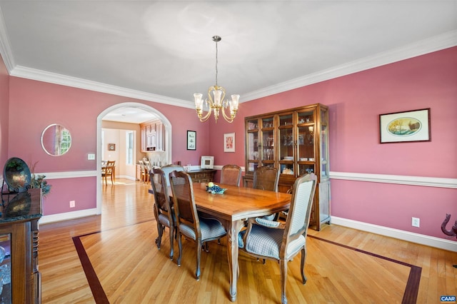 2865 Proffit Rd, Charlottesville, VA 22911 - dining room with arched walkways, light wood-type flooring, a chandelier, and crown molding