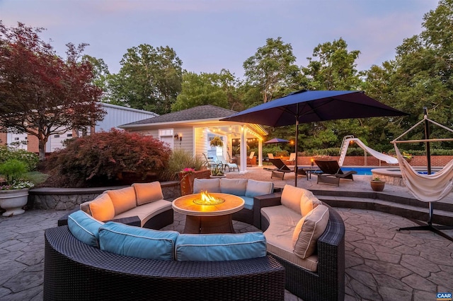 2865 Proffit Rd, Charlottesville, VA 22911 - patio terrace at dusk with an outdoor living space with a fire pit, a patio area, and an outbuilding