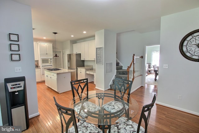 8011 Lions Crest Way, Gaithersburg, MD 20879 - dining room with light wood finished floors, stairway, and recessed lighting