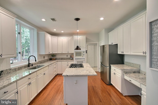 8011 Lions Crest Way, Gaithersburg, MD 20879 - kitchen with appliances with stainless steel finishes, a kitchen island, light wood-style flooring, white cabinets, and recessed lighting
