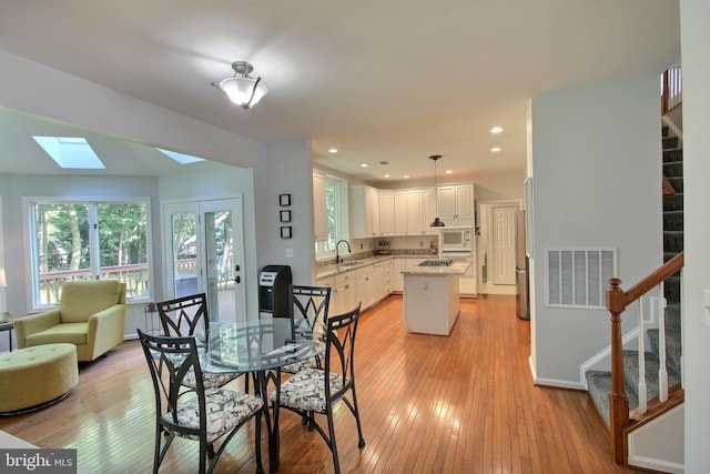 8011 Lions Crest Way, Gaithersburg, MD 20879 - dining room with stairs, light wood finished floors, healthy amount of natural light, and recessed lighting