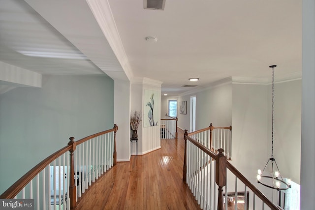 8011 Lions Crest Way, Gaithersburg, MD 20879 - hallway featuring an upstairs landing, ornamental molding, wood finished floors, and a chandelier