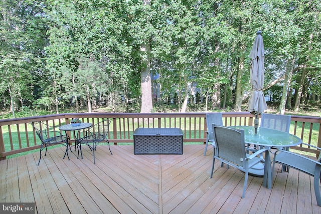 8011 Lions Crest Way, Gaithersburg, MD 20879 - wooden terrace featuring outdoor dining space, a lawn, and view of wooded area
