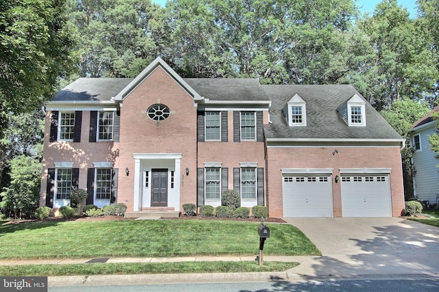 8011 Lions Crest Way, Gaithersburg, MD 20879 - colonial home with concrete driveway, brick siding, a front lawn, and a garage
