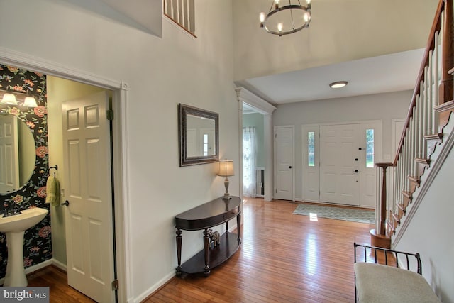 8011 Lions Crest Way, Gaithersburg, MD 20879 - foyer entrance with a chandelier, hardwood / wood-style flooring, stairs, and a high ceiling