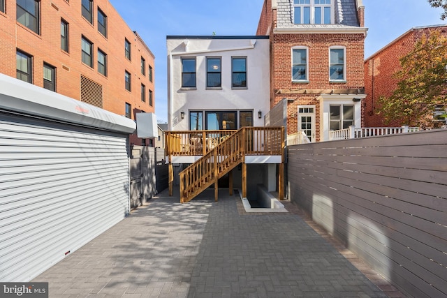 1720 15th St NW, Washington, DC 20009 - rear view of property featuring brick siding, mansard roof, and stairs