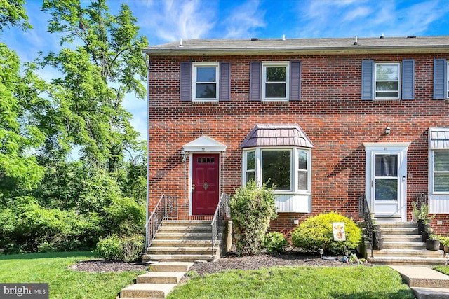 38 Fairfax Vlg, Harrisburg, PA 17112 - view of front facade with brick siding and a front yard