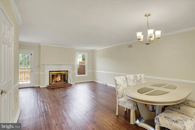 38 Fairfax Vlg, Harrisburg, PA 17112 - dining area with dark wood-type flooring, a chandelier, ornamental molding, and a brick fireplace