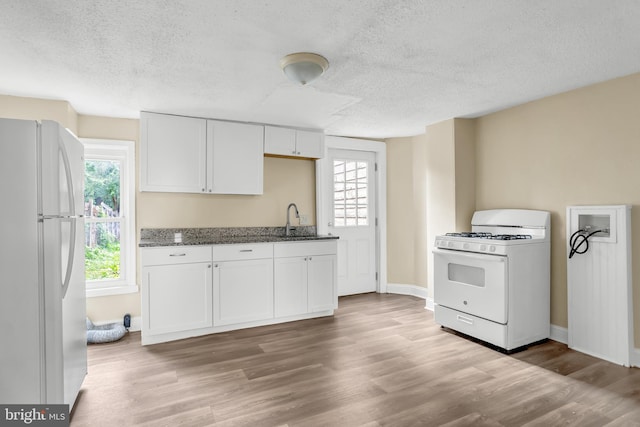 204 S Sherman St, York, PA 17403 - kitchen with white appliances, dark stone counters, a textured ceiling, white cabinetry, and wood finished floors