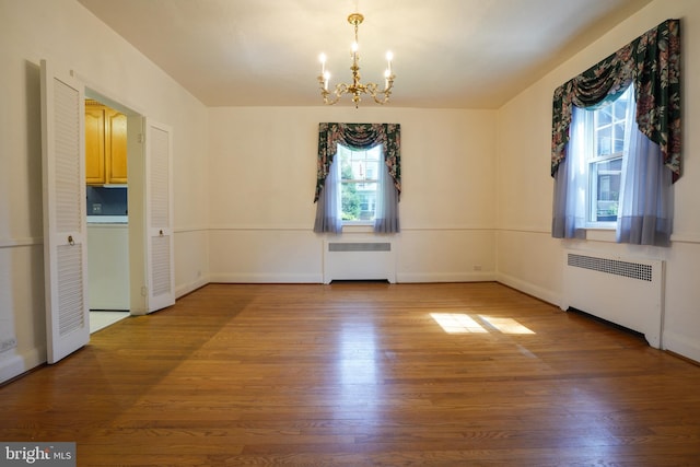 6339 Frederick Rd, Baltimore, MD 21228 - unfurnished dining area featuring radiator, a chandelier, and wood finished floors