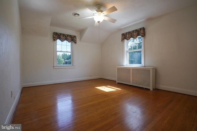 6339 Frederick Rd, Baltimore, MD 21228 - bonus room featuring radiator, wood-type flooring, healthy amount of natural light, a ceiling fan, and vaulted ceiling