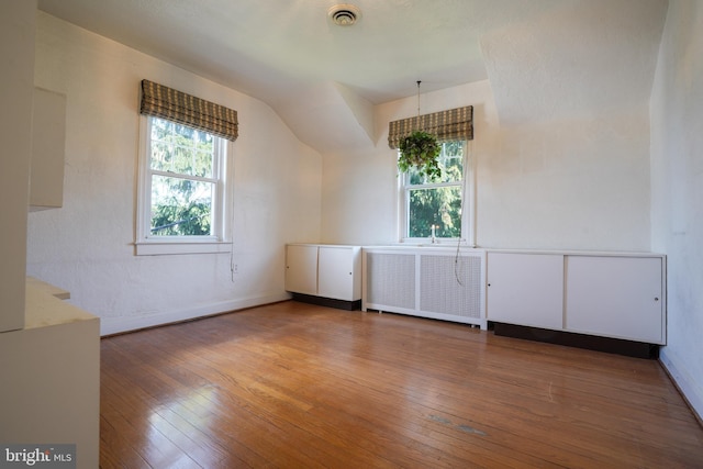 6339 Frederick Rd, Baltimore, MD 21228 - additional living space featuring radiator, wood-type flooring, and vaulted ceiling
