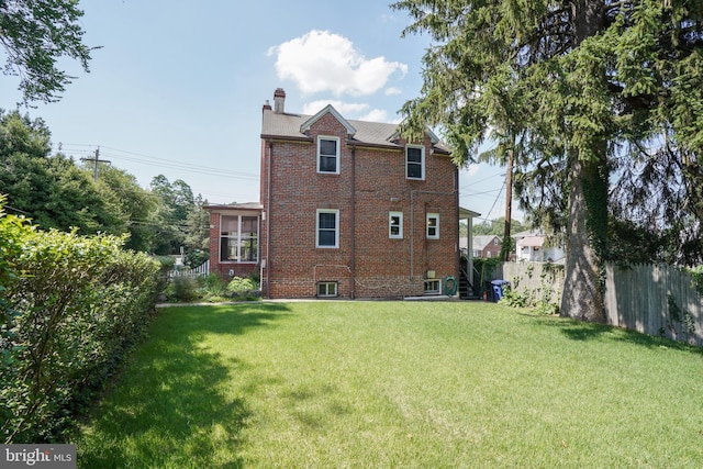 6339 Frederick Rd, Baltimore, MD 21228 - rear view of property featuring brick siding and a chimney