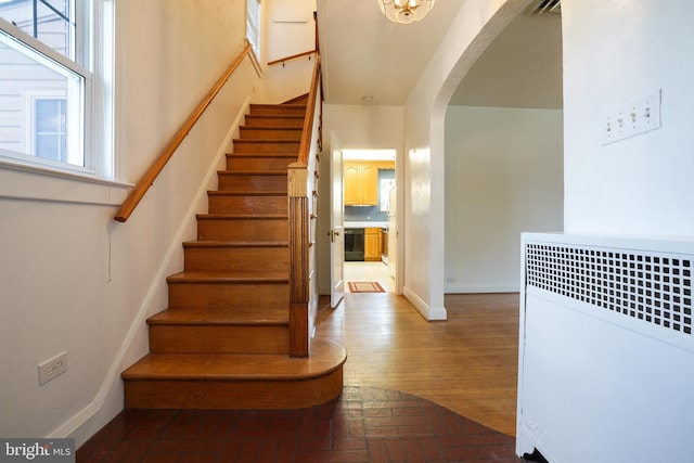 6339 Frederick Rd, Baltimore, MD 21228 - staircase with arched walkways, brick floors, and wine cooler