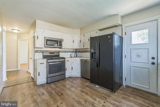 3122 Byberry Rd, Philadelphia, PA 19154 - kitchen featuring appliances with stainless steel finishes, white cabinets, light countertops, and decorative backsplash