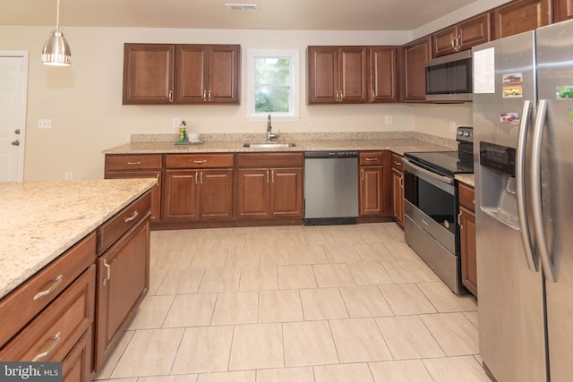 3923 Fairview Ave, Baltimore, MD 21216 - kitchen with appliances with stainless steel finishes, light stone countertops, and hanging light fixtures