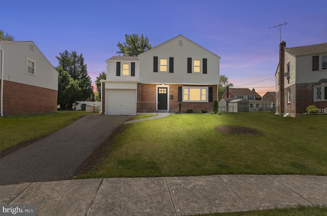 513 Ridley Cir, Morton, PA 19070 - view of front facade featuring brick siding, driveway, a front lawn, and a garage