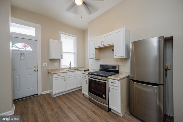2812 Auchentoroly Ter, Baltimore, MD 21217 - kitchen with appliances with stainless steel finishes, ceiling fan, white cabinetry, and dark wood-style flooring