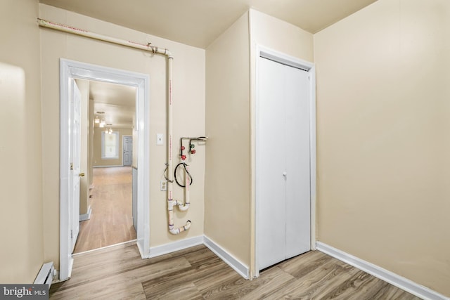 409 N Franklin St, Wilmington, DE 19805 - hallway featuring light wood finished floors and a baseboard radiator