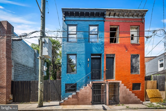 1406 Lemmon St, Baltimore, MD 21223 - view of front of house featuring a fenced front yard, brick siding, and a gate