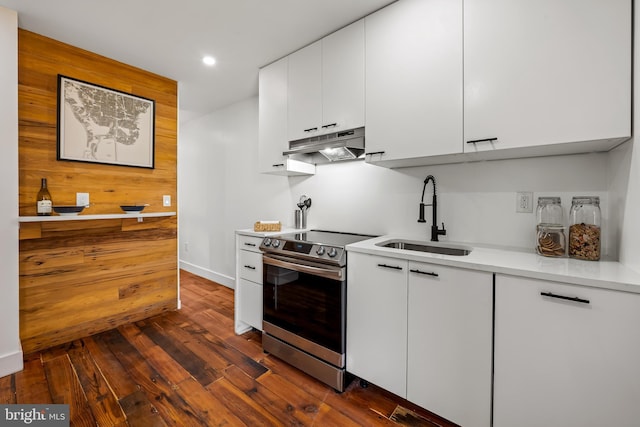 1406 Lemmon St, Baltimore, MD 21223 - kitchen with electric range, under cabinet range hood, light countertops, white cabinets, and recessed lighting