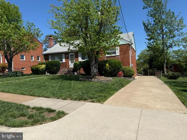 5915 Craig St, Springfield, VA 22150 - view of front of property featuring a front lawn, driveway, and brick siding