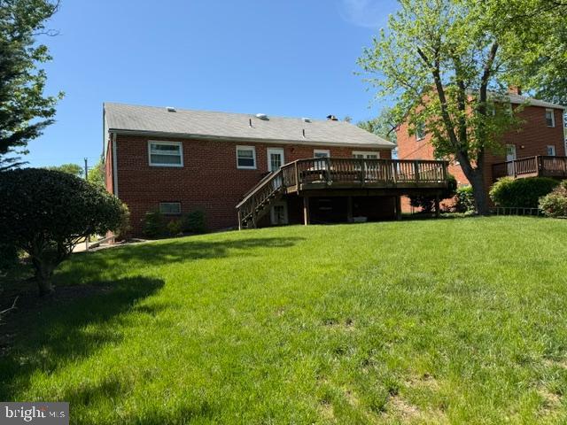 5915 Craig St, Springfield, VA 22150 - back of property with a deck, stairs, a yard, and brick siding