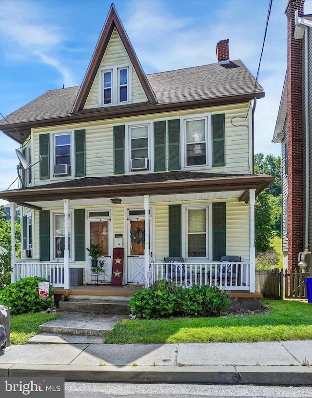 216 Hanover St, Glen Rock, PA 17327 - view of front facade featuring covered porch, a shingled roof, cooling unit, and a chimney