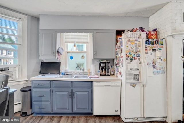 216 Hanover St, Glen Rock, PA 17327 - kitchen featuring white appliances, gray cabinets, wood finished floors, and brick wall