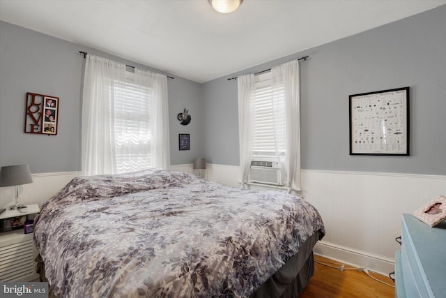 216 Hanover St, Glen Rock, PA 17327 - bedroom with wainscoting, cooling unit, and wood finished floors