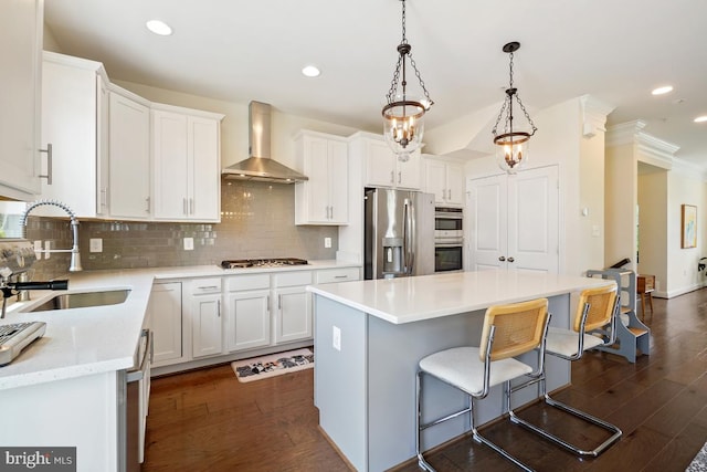12150 Grey Squirrel St, Clarksburg, MD 20871 - kitchen with wall chimney range hood, appliances with stainless steel finishes, dark wood-style flooring, tasteful backsplash, and a breakfast bar area