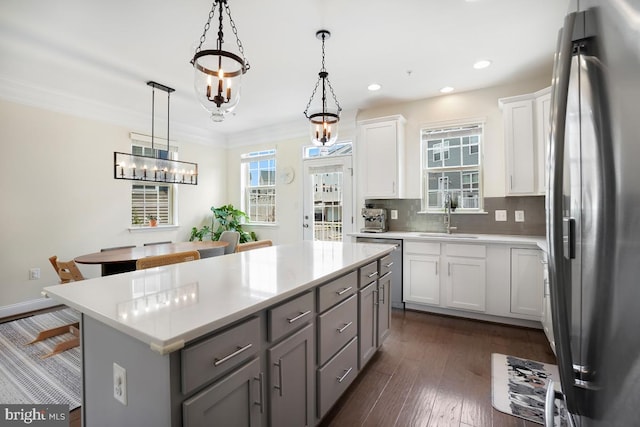12150 Grey Squirrel St, Clarksburg, MD 20871 - kitchen with stainless steel appliances, a kitchen island, light countertops, white cabinets, and pendant lighting