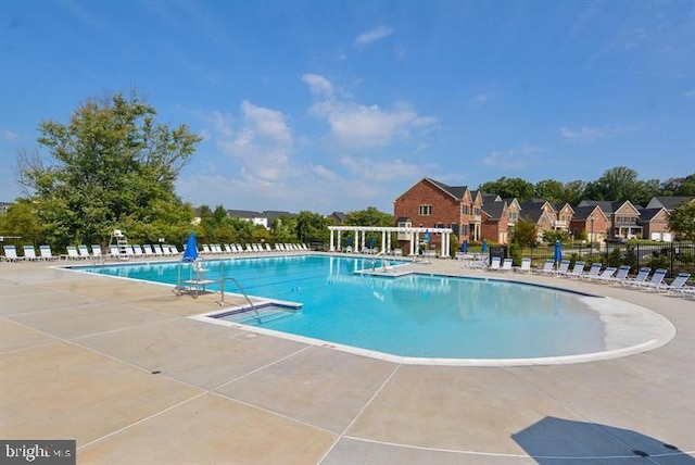 12150 Grey Squirrel St, Clarksburg, MD 20871 - community pool with a patio, a pergola, and a residential view