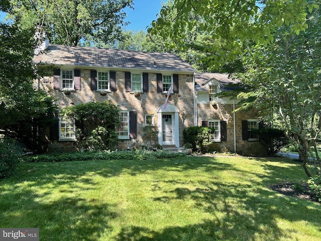 406 Devon State Rd, Devon, PA 19333 - colonial-style house with a front yard, a chimney, and stone siding