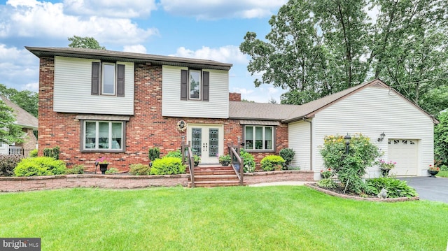 32 Lakeshore Dr, Hammonton, NJ 08037 - view of front of property featuring french doors, a garage, asphalt driveway, a front yard, and brick siding