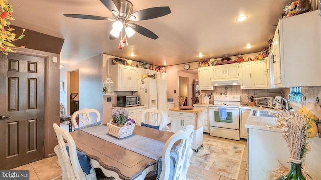 32 Lakeshore Dr, Hammonton, NJ 08037 - kitchen with white appliances, under cabinet range hood, light tile patterned floors, tasteful backsplash, and ceiling fan