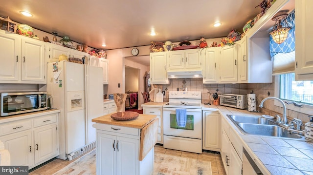 32 Lakeshore Dr, Hammonton, NJ 08037 - kitchen featuring white appliances, tile counters, under cabinet range hood, backsplash, and white cabinets