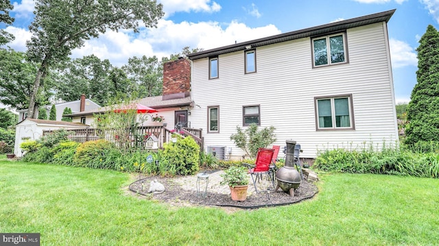32 Lakeshore Dr, Hammonton, NJ 08037 - back of house with a lawn, a chimney, and a deck