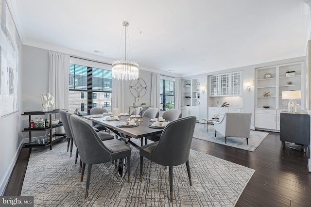 43561 Michigan Sq, Leesburg, VA 20176 - dining space featuring built in shelves, dark wood finished floors, a chandelier, and crown molding