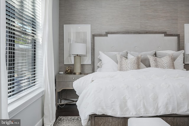 43561 Michigan Sq, Leesburg, VA 20176 - bedroom featuring multiple windows, wood finished floors, and wallpapered walls