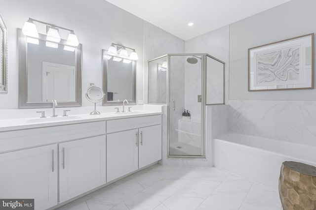 43561 Michigan Sq, Leesburg, VA 20176 - bathroom with double vanity, a stall shower, a garden tub, and marble look tiles