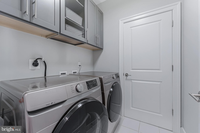 43561 Michigan Sq, Leesburg, VA 20176 - washroom with cabinet space, separate washer and dryer, and light tile patterned floors