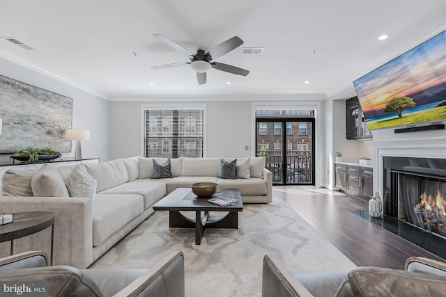 43561 Michigan Sq, Leesburg, VA 20176 - living area featuring light wood-style flooring, a ceiling fan, ornamental molding, recessed lighting, and a fireplace with flush hearth