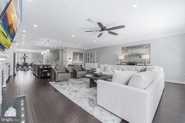 43561 Michigan Sq, Leesburg, VA 20176 - living room featuring stairs, a ceiling fan, recessed lighting, dark wood-style floors, and ornamental molding