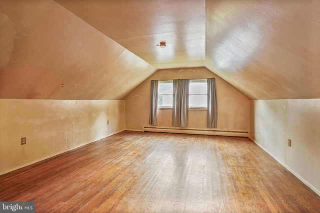 1531 Aiden Dr, Woodbridge, VA 22191 - additional living space with baseboard heating, hardwood / wood-style floors, and vaulted ceiling