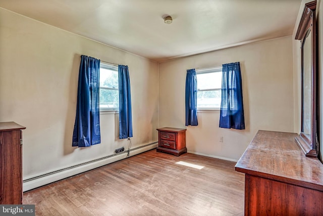 1531 Aiden Dr, Woodbridge, VA 22191 - empty room with a baseboard radiator, plenty of natural light, wood finished floors, and a smoke detector