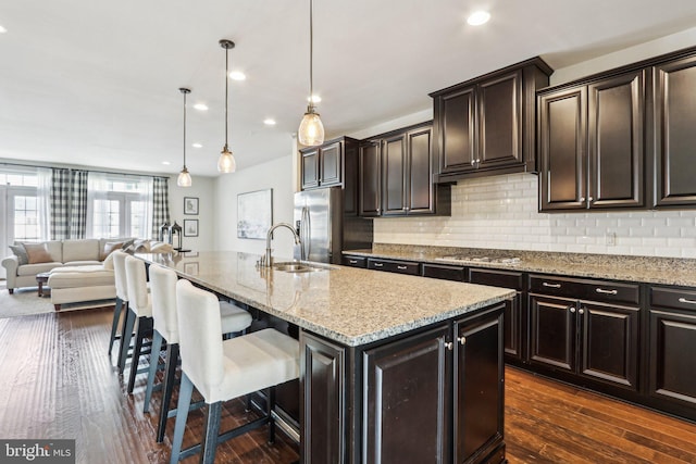 221 Patriots Path, Malvern, PA 19355 - kitchen with stainless steel appliances, a kitchen breakfast bar, light stone counters, backsplash, and recessed lighting