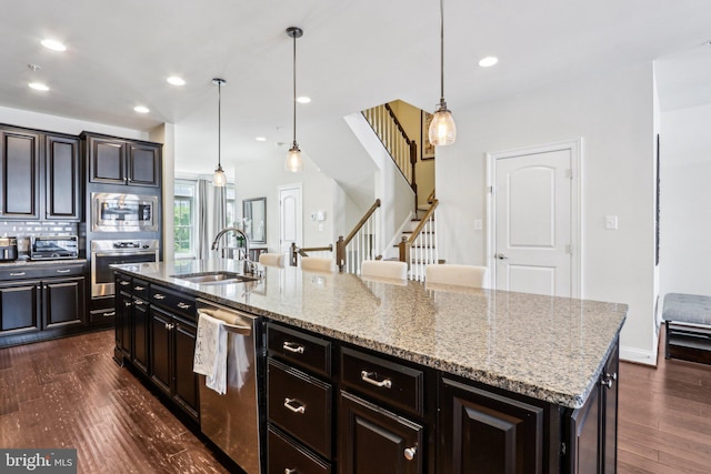 221 Patriots Path, Malvern, PA 19355 - kitchen featuring stainless steel appliances, dark wood-style flooring, recessed lighting, light stone countertops, and hanging light fixtures